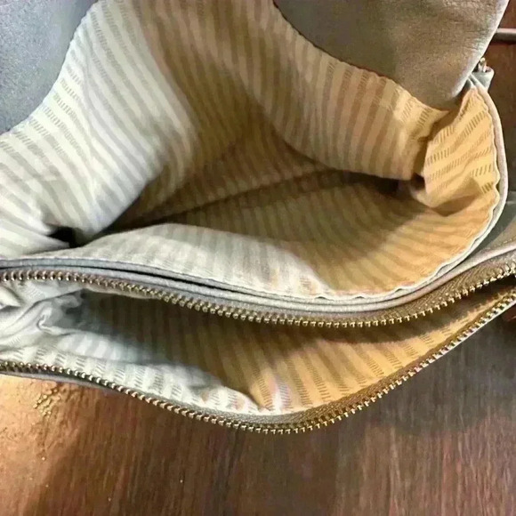 Grey Fold over Purse. Wristlet Strap. Shoulder Strap. Pockets. Zipper. Snap. - Picture 4 of 7